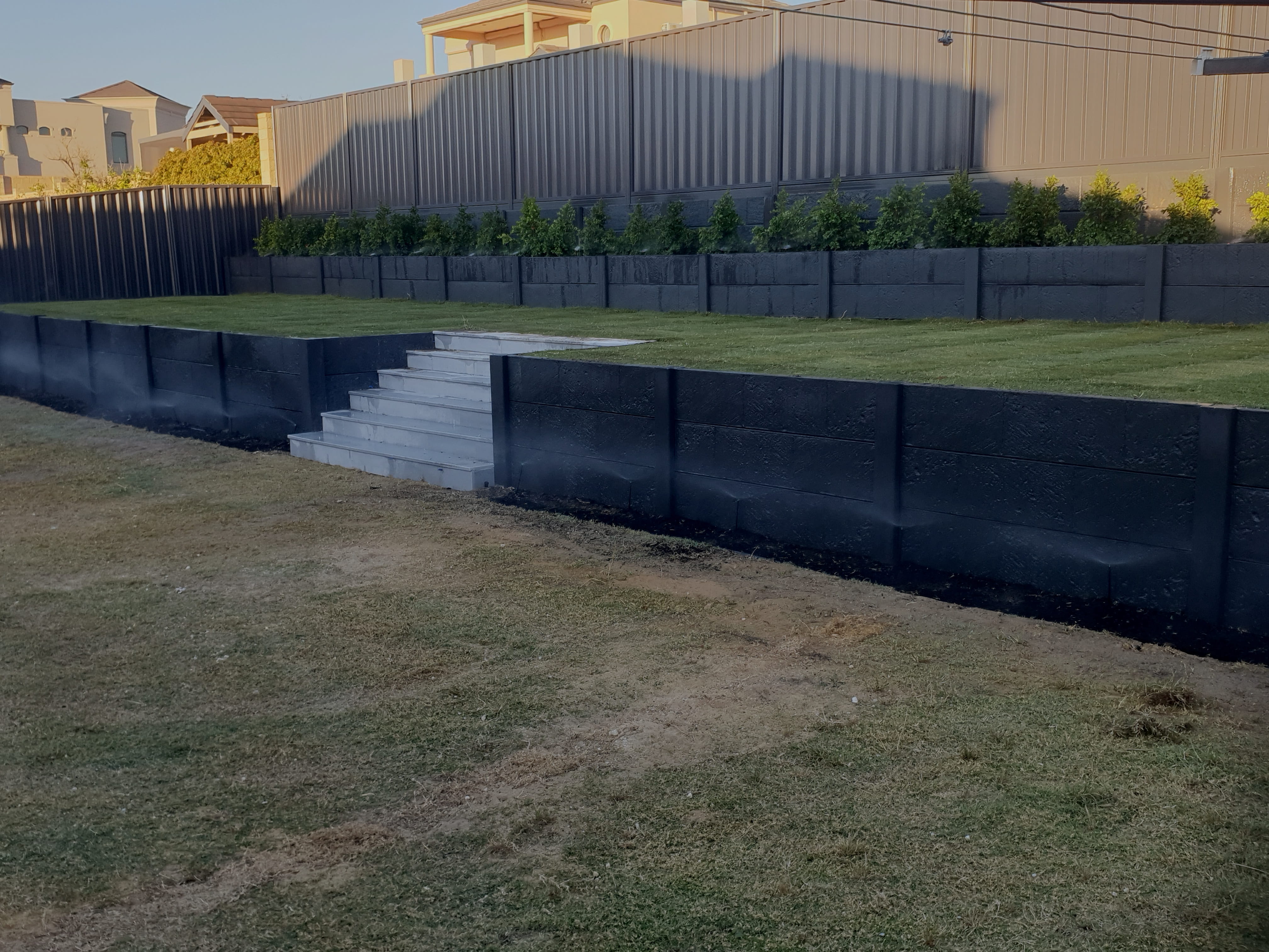 Completed driveway replacement and front yard landscaping project in Perth at dusk