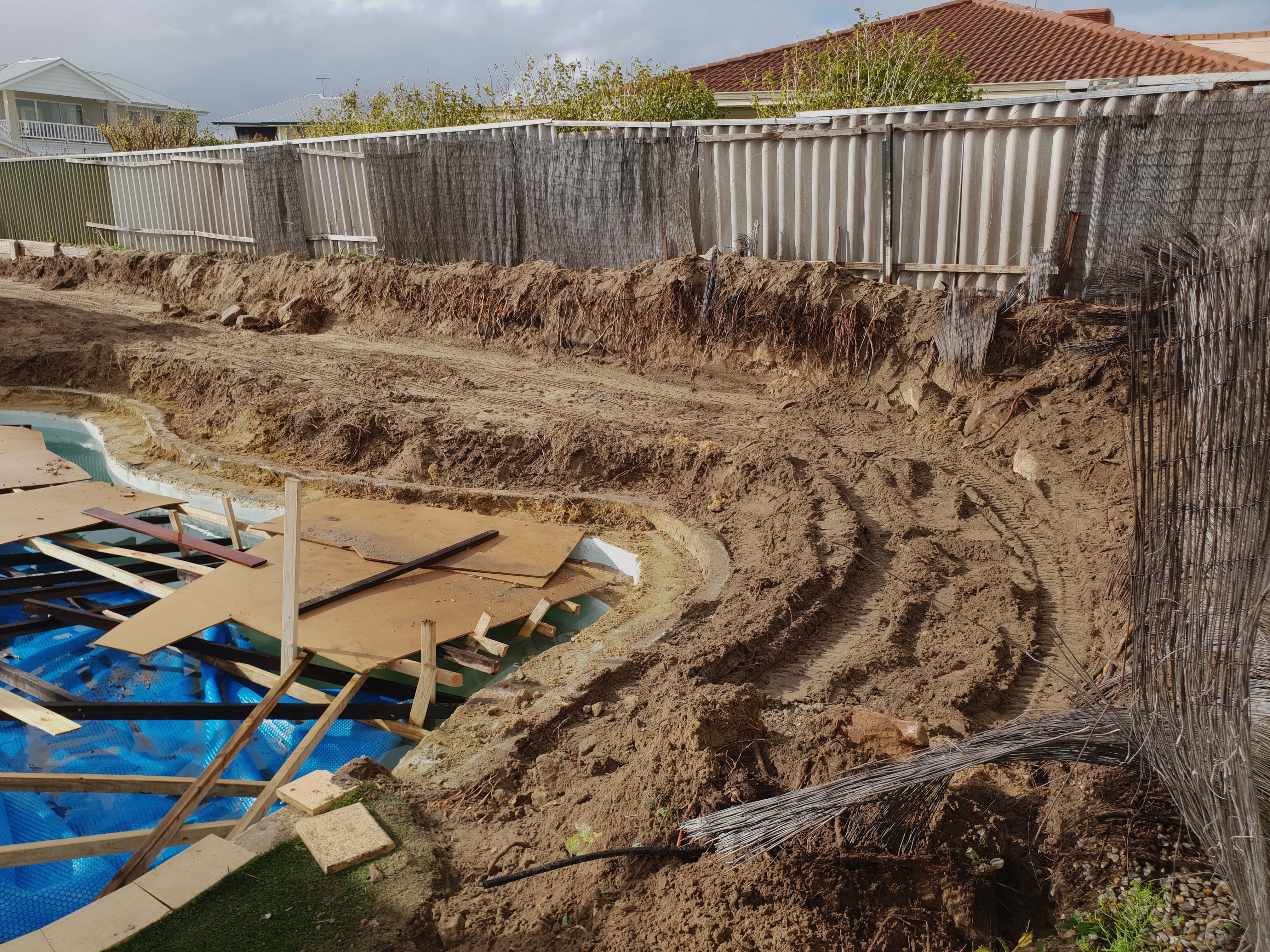 Uneven yard before retaining wall construction